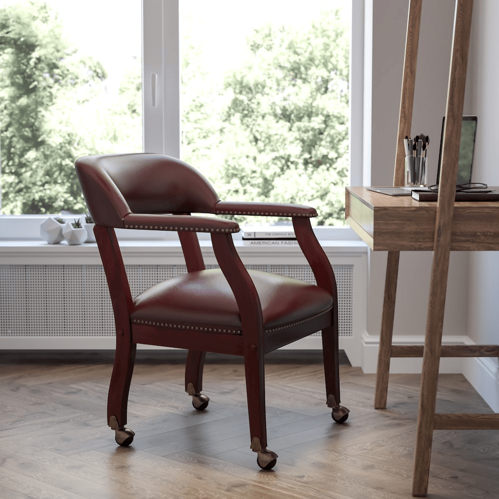 Oxblood Vinyl Luxurious Conference Chair with Accent Nail Trim and Casters - Mervyns